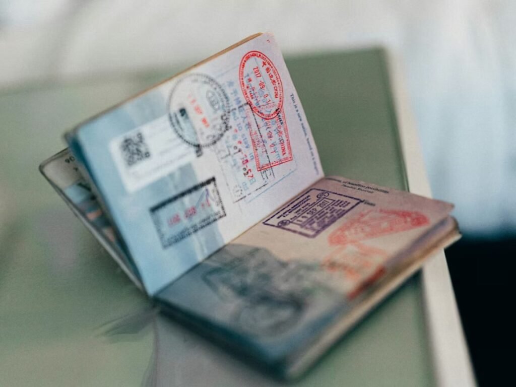 How much money do you need to live comfortably in Dubai — UAE residence visa documents and passport on desk