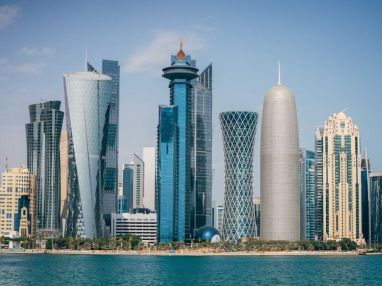 What is a good salary to live in Doha — expat walking through West Bay financial district with skyline in background